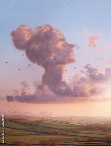 A lady in the clouds -  Women's head shaped cloud on a landscape sunset scenic. thinking and mindful conceptual Illustration. photo