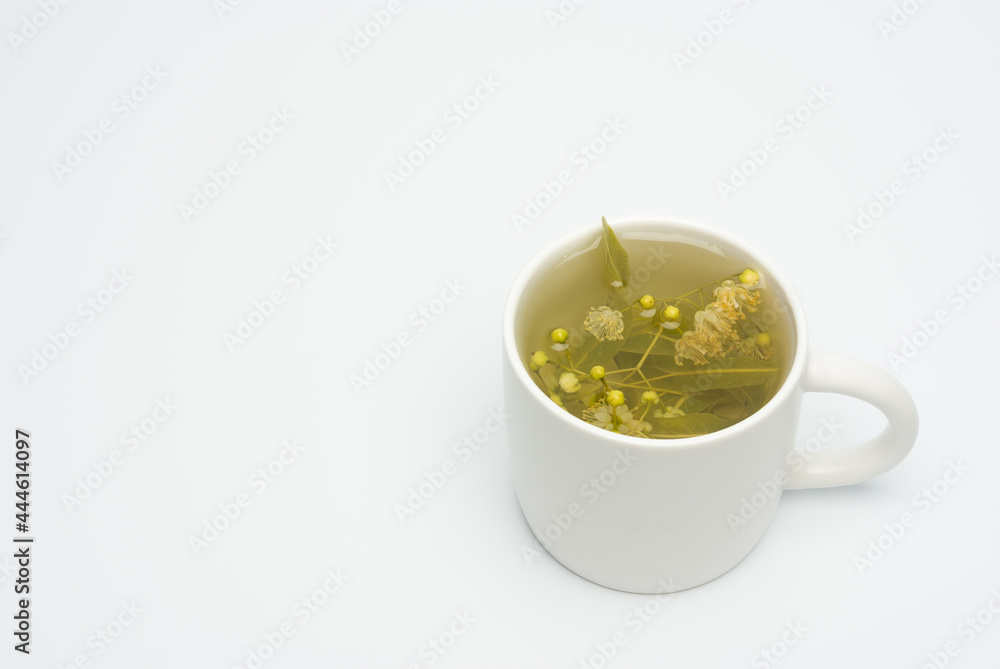 Linden flowers in a cup isolated on white background, linden tea