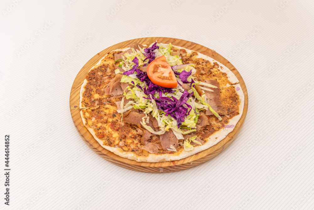 Arab kebab pizza, lahmacun with purple cabbage, tomato, grated iceberg lettuce on wooden plate. Arab kebab pizza, lahmacun with purple cabbage, tomato, grated iceberg lettuce on wooden plate.