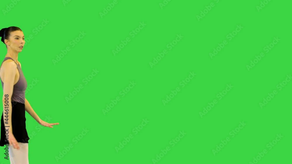Young ballerina in training clothes exercises jump on a Green Screen, Chroma Key. Young ballerina in training clothes exercises jump on a Green Screen, Chroma Key.