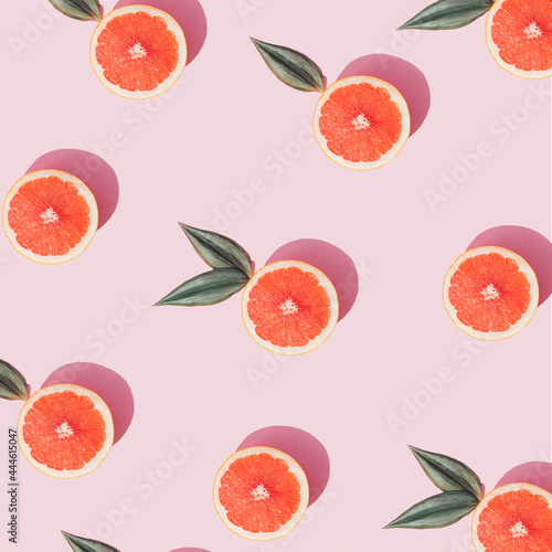 Fototapeta Naklejka Na Ścianę i Meble -  Trendy Summer arangement made with fresh grapefruit slices on pastel pink background. Creative flat lay.