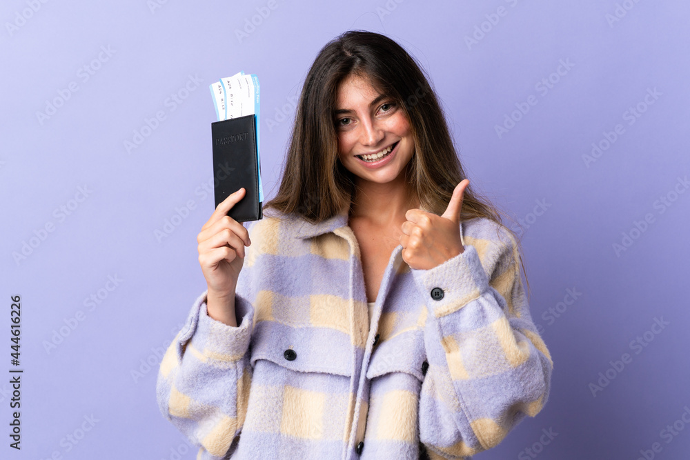 Young caucasian woman isolated on purple background in vacation holding a passport and plane with thumb up Young caucasian woman isolated on purple background in vacation holding a passport and plane with thumb up