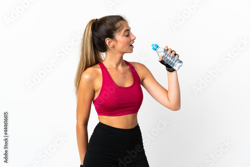 Young caucasian woman isolated on white background with sports water bottle