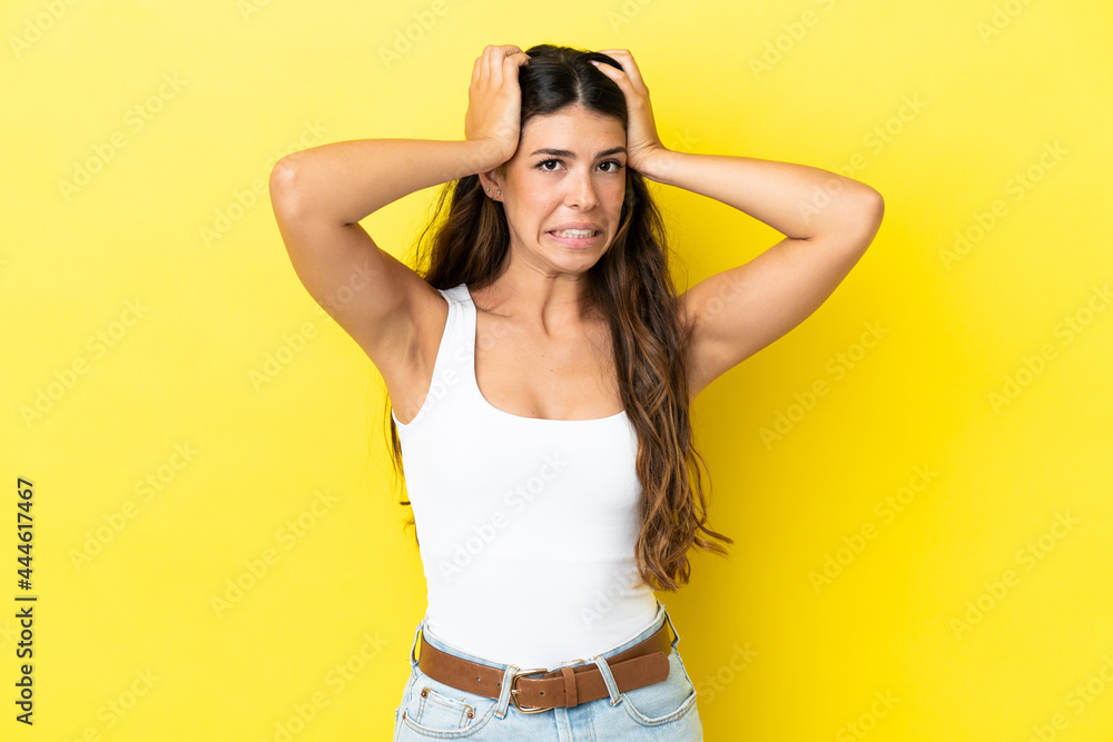Young caucasian woman isolated on yellow background doing nervous gesture