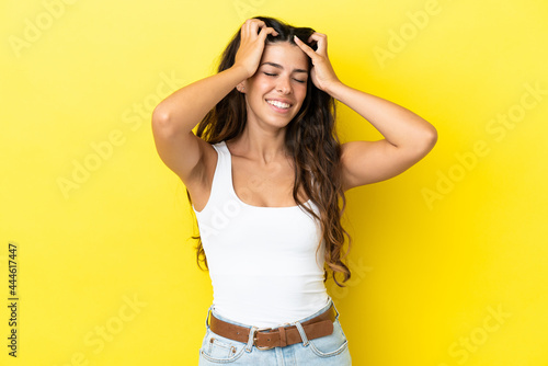 Young caucasian woman isolated on yellow background laughing © luismolinero