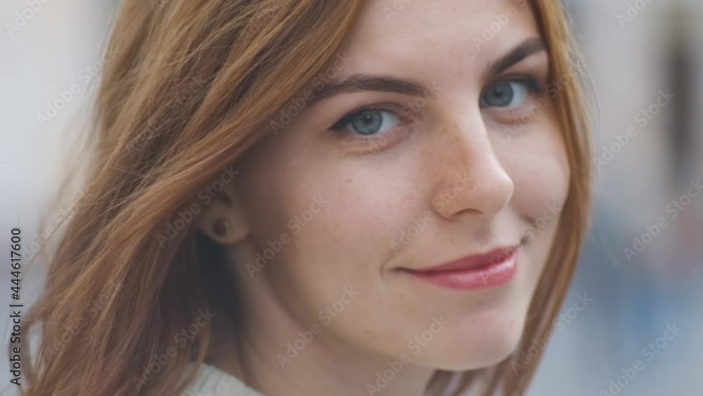 portrait of beautiful red-haired young woman on street in slow motion portrait of beautiful red-haired young woman on street in slow motion