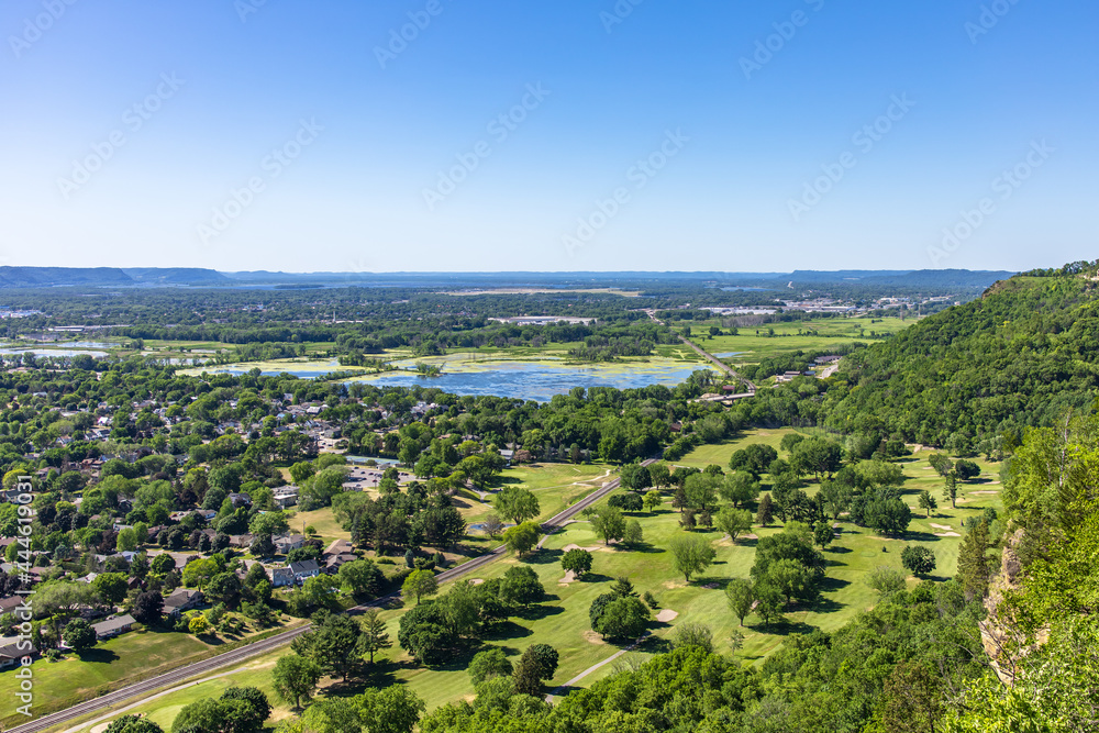 Viewpoint scene of greenery bluff, natural forest and highway with clear blue sky in countryside. Beautiful horizontal landscape with skyline, calmness and tranquility of green environment.