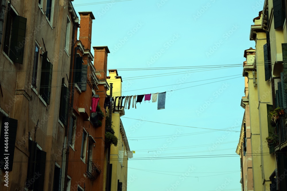 Clothes drying on a clothesline between two buildings in Venice. Stock