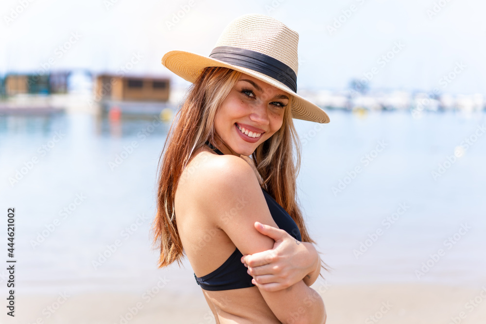 Young pretty blonde girl in swimsuit in summer holidays