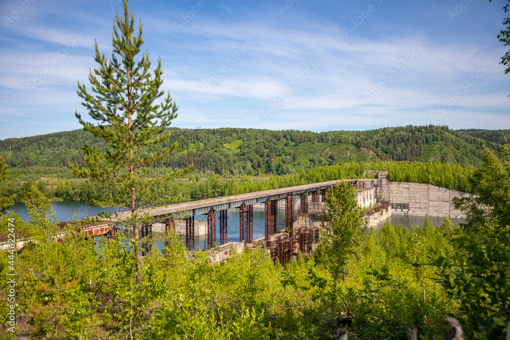 View of abandoned hydroelectric power plant on the Taidon River in Siberia, Russia