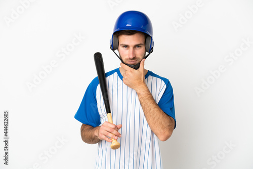 Young caucasian man playing baseball isolated on white background thinking