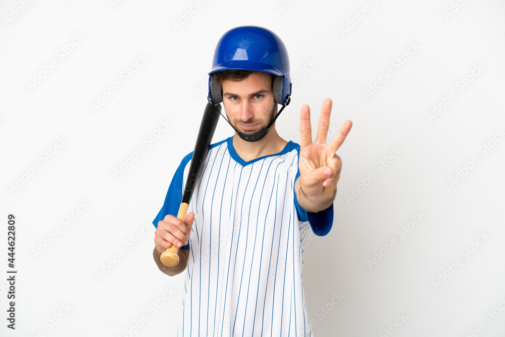 Young caucasian man playing baseball isolated on white background happy and counting three with fingers