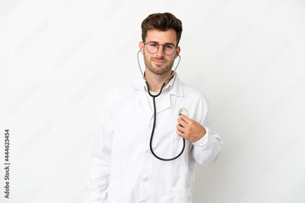 Young doctor caucasian man over isolated on white background wearing a doctor gown and with stethoscope Young doctor caucasian man over isolated on white background wearing a doctor gown and with stethoscope