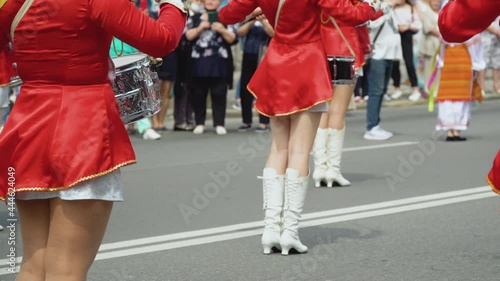 Young girls drummer in red vintage uniform at the parade. Street performance. Parade of majorettes