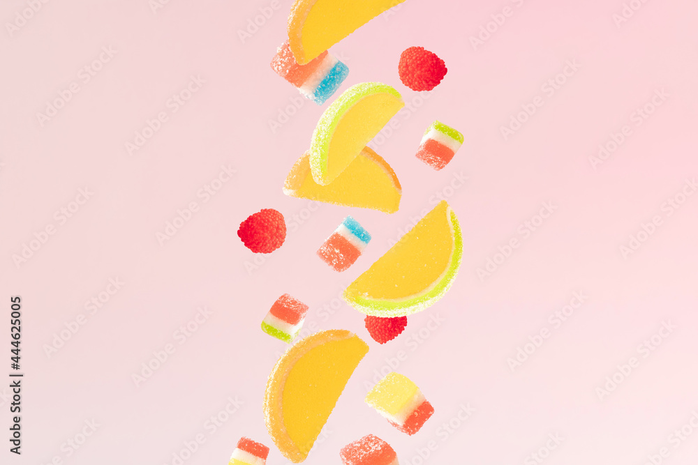 Colorful jelly falling sweets. Pink background. Minimal design.