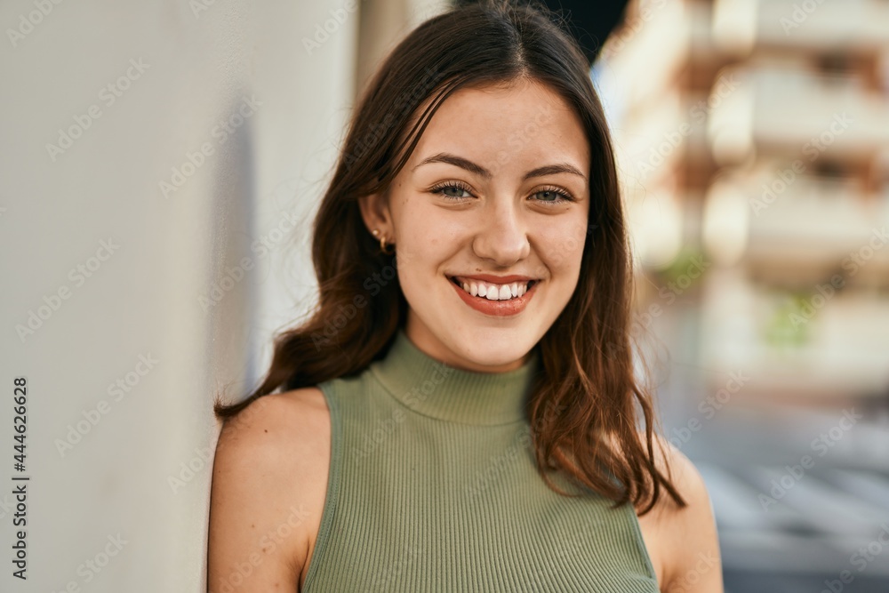 Young caucasian girl smiling happy standing at the city.