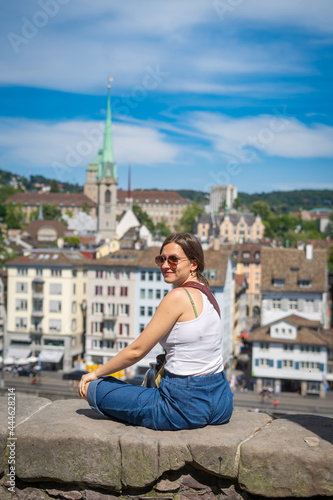 beautiful girl travelling in Zurich taking photo with landscape in Zurich, Switzerland