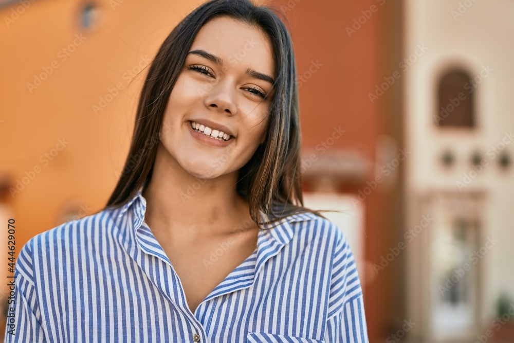 Young hispanic girl smiling happy standing at the city. Young hispanic girl smiling happy standing at the city.