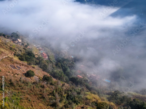 Aerial view of Itaipava, Petrópolis. Early morning with a lot of fog in the city. Mountains with blue sky and clouds around Petrópolis, mountainous region of Rio de Janeiro, Brazil. Drone photo.  photo