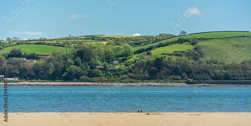 View of LLansteffan beach in southern Wales surrounded by sand and green hills photo