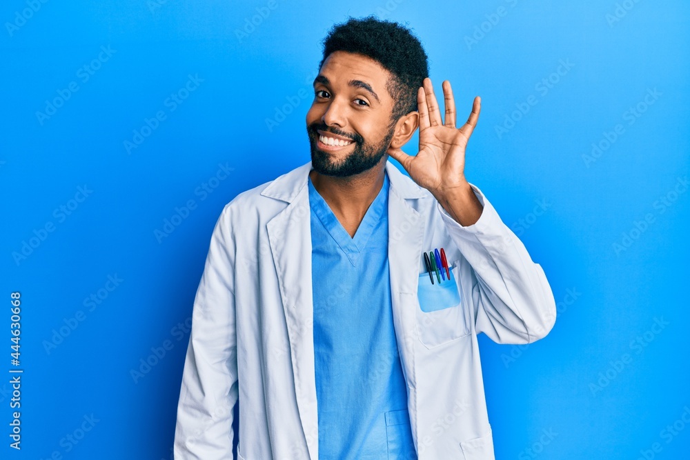 Handsome hispanic man with beard wearing doctor uniform smiling with hand over ear listening an hearing to rumor or gossip. deafness concept. Handsome hispanic man with beard wearing doctor uniform smiling with hand over ear listening an hearing to rumor or gossip. deafness concept.
