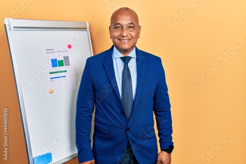 Middle age latin man wearing business clothes on chart presentation with a happy and cool smile on face. lucky person.