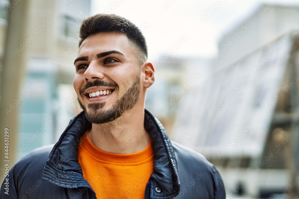 Handsome hispanic man with beard smiling happy and confident at the city wearing winter coat Handsome hispanic man with beard smiling happy and confident at the city wearing winter coat