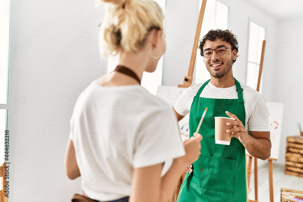 Obraz premium Young artist couple smiling happy standing at art studio.