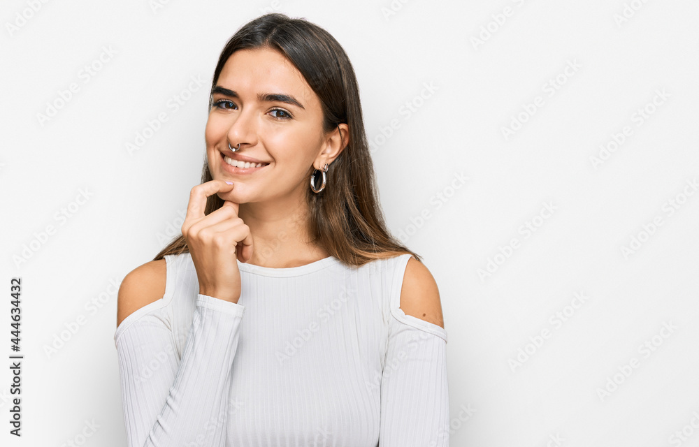 Young hispanic woman wearing casual clothes looking confident at the camera with smile with crossed arms and hand raised on chin. thinking positive. Young hispanic woman wearing casual clothes looking confident at the camera with smile with crossed arms and hand raised on chin. thinking positive.