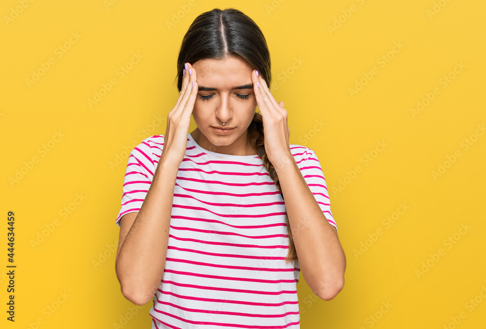 Young hispanic woman wearing casual clothes with hand on head for pain in head because stress. suffering migraine. Young hispanic woman wearing casual clothes with hand on head for pain in head because stress. suffering migraine.