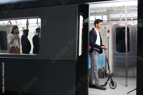 Passenger with casual suit  in the Skytrain rails or subway for travel in the big city, lifestyle and transportation concept photo