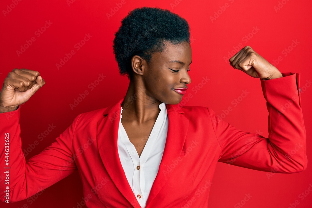 Young african american girl wearing business clothes showing arms muscles smiling proud. fitness concept. Young african american girl wearing business clothes showing arms muscles smiling proud. fitness concept.