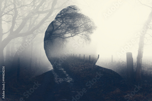 Fotografie A double exposure of a spooky half transparent hooded figure