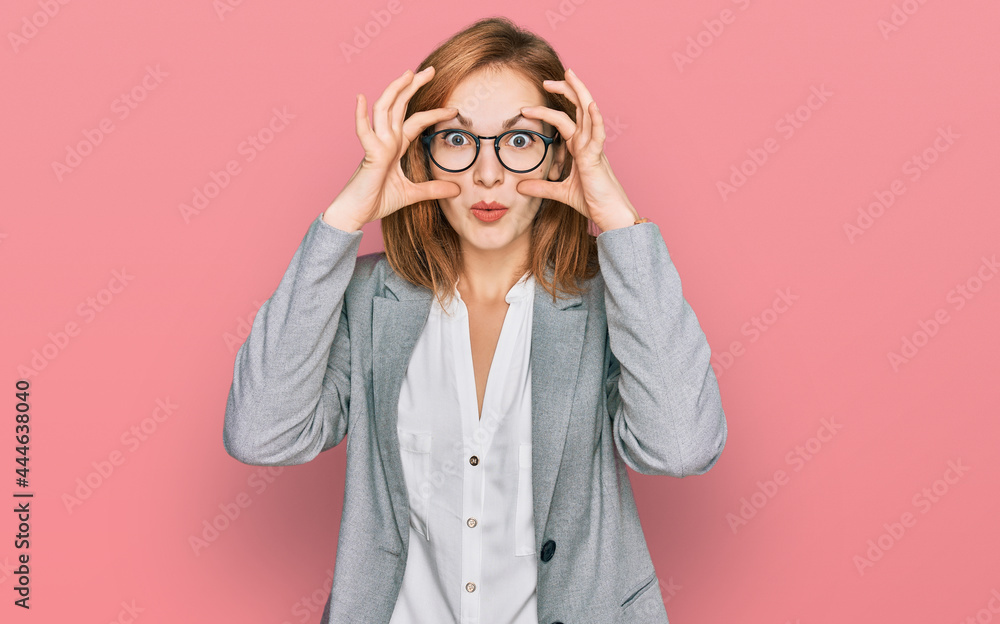 Young caucasian woman wearing business style and glasses trying to open eyes with fingers, sleepy and tired for morning fatigue Young caucasian woman wearing business style and glasses trying to open eyes with fingers, sleepy and tired for morning fatigue