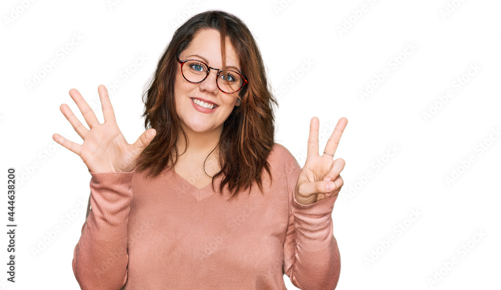 Young plus size woman wearing casual clothes and glasses showing and pointing up with fingers number seven while smiling confident and happy. Young plus size woman wearing casual clothes and glasses showing and pointing up with fingers number seven while smiling confident and happy.