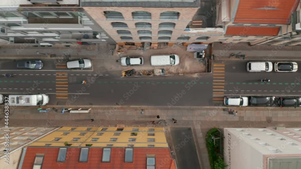Aerial birds eye overhead top down tracking view of people riding bikes on cycle route in Linienstrasse. Promoting green transport in city. Berlin, Germany. Aerial birds eye overhead top down tracking view of people riding bikes on cycle route in Linienstrasse. Promoting green transport in city. Berlin, Germany.