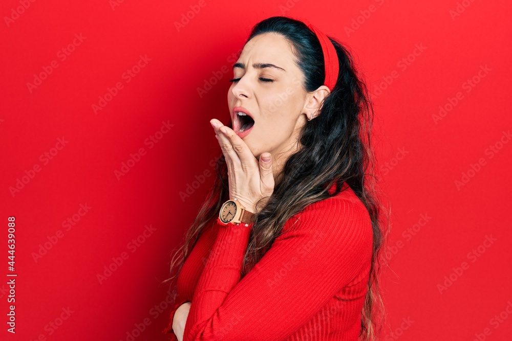 Young hispanic woman wearing casual clothes bored yawning tired covering mouth with hand. restless and sleepiness. Young hispanic woman wearing casual clothes bored yawning tired covering mouth with hand. restless and sleepiness.
