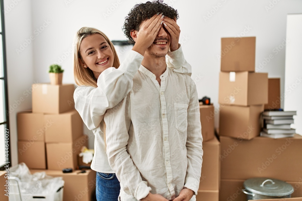 Girl surprising his boyfriend covering eyes at new home. Girl surprising his boyfriend covering eyes at new home.