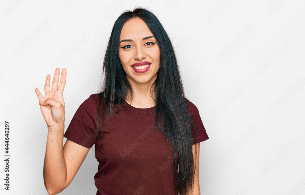 Young hispanic girl wearing casual t shirt showing and pointing up with fingers number four while smiling confident and happy. Young hispanic girl wearing casual t shirt showing and pointing up with fingers number four while smiling confident and happy.