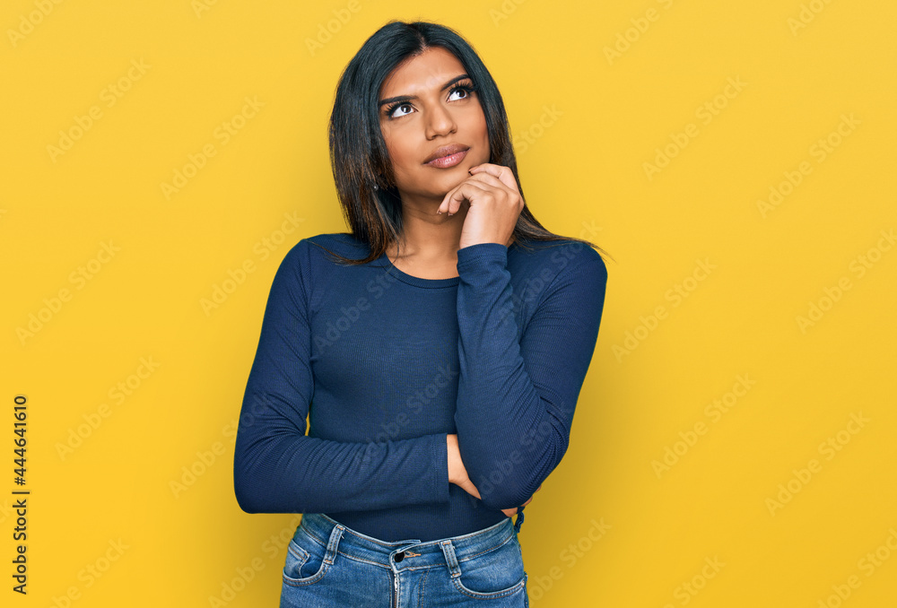 Young adult Hispanic transsexual girl covering her undeveloped breasts with  her hands. Concept of transsexuality, inclusion and diversity. Stock Photo