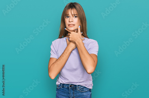 Teenager caucasian girl wearing casual clothes shouting and suffocate because painful strangle. health problem. asphyxiate and suicide concept.