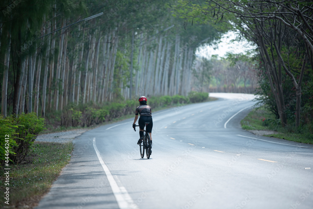 Asian woman are cycling road bike in the morning Asian woman are cycling road bike in the morning