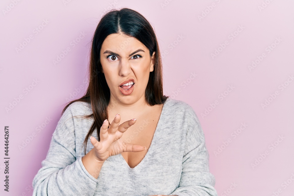 Young hispanic woman wearing casual clothes disgusted expression, displeased and fearful doing disgust face because aversion reaction. with hands raised Young hispanic woman wearing casual clothes disgusted expression, displeased and fearful doing disgust face because aversion reaction. with hands raised