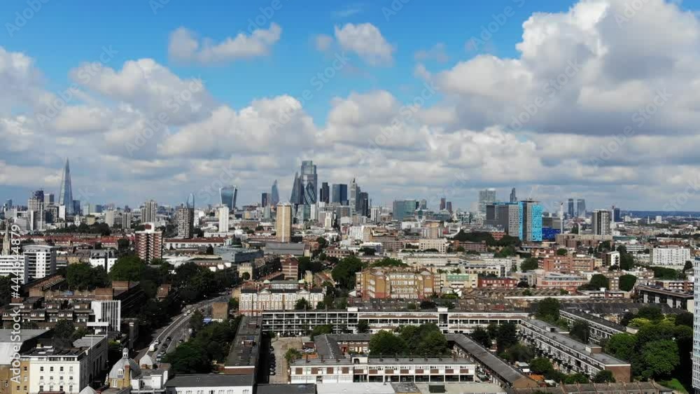 Aerial shot of London skyline against white puffy clouds on a sunny summer day Aerial shot of London skyline against white puffy clouds on a sunny summer day