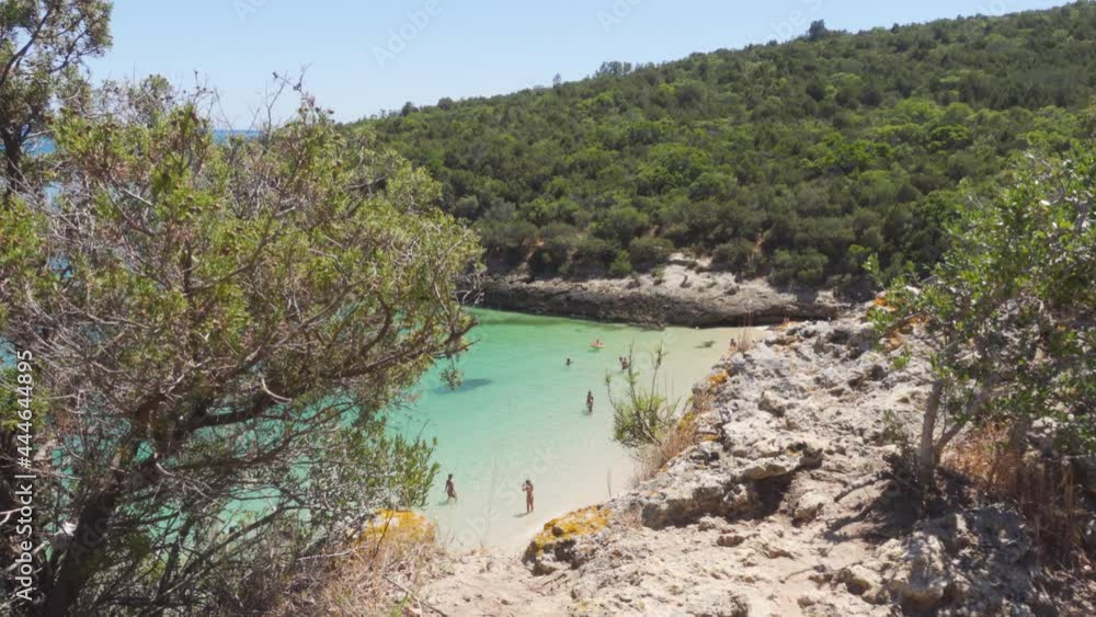 A Hidden Tropical Cove visible through the Bushes near Galapinhos, Portugal A Hidden Tropical Cove visible through the Bushes near Galapinhos, Portugal
