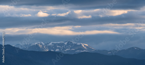 Gloomy weather in the mountains, evening light. Panoramic view. © Valerii