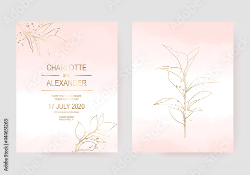 Delicate wedding invitation cards with gold leaf on pale pink watercolor texture.