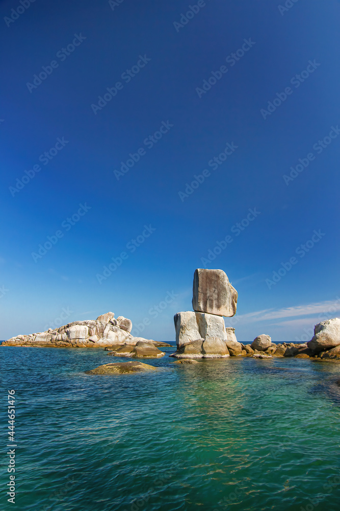 Thailand travel island Koh Lipe stonehenge pinnacle in far ocean sea with big large stone overlap and sunny clear blue sky background landscape