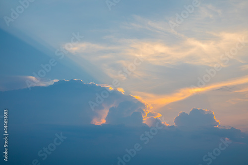 Dramatic sun ray with blue orange color sky and clouds dawn texture background. New heaven and earth concept.