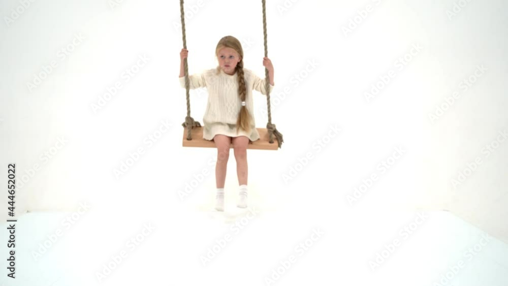Cute long haired girl sitting on rope swing Cute long haired girl sitting on rope swing
